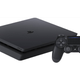 A PlayStation 4 controller sits next to a console.